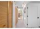 Bright hallway with storage, skylight and light wood-style flooring that leads to other rooms at 2571 Ames Haven Rd, Kissimmee, FL 34744