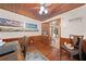Bright home office with wood-paneled walls, hardwood floors, and a charming display shelf at 2571 Ames Haven Rd, Kissimmee, FL 34744