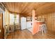 Cozy kitchen and dining area with wood-paneled walls and stainless steel appliances for cooking and gathering at 2571 Ames Haven Rd, Kissimmee, FL 34744