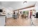 Open concept kitchen featuring hardwood floors, wooden beams and an adjacent dining area, ideal for gatherings at 2571 Ames Haven Rd, Kissimmee, FL 34744