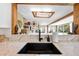 Bright kitchen with white marble countertops, open to the living room, and a skylight at 2571 Ames Haven Rd, Kissimmee, FL 34744