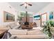 Cozy living room with a brick fireplace, comfortable sofas, and natural light from clerestory windows at 2571 Ames Haven Rd, Kissimmee, FL 34744