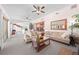 Spacious living area leading to the dining room, featuring cozy sofas and ample natural light at 2571 Ames Haven Rd, Kissimmee, FL 34744