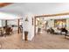 Open-concept living room with hardwood floors, wooden beams, and bright lighting, creating a welcoming atmosphere at 2571 Ames Haven Rd, Kissimmee, FL 34744