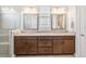 Bathroom includes double sinks, granite counters, updated fixtures, and glass shower at 2621 Redblush Ter, St Cloud, FL 34772