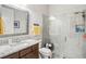 Bathroom features a glass enclosed shower, granite counters, and updated fixtures at 2621 Redblush Ter, St Cloud, FL 34772