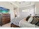 Bedroom featuring a ceiling fan, neutral paint, television and large bed at 2621 Redblush Ter, St Cloud, FL 34772