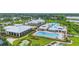 Overhead view of a comprehensive community clubhouse featuring pools, sports courts, and recreational facilities at 2621 Redblush Ter, St Cloud, FL 34772
