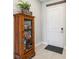 Inviting entryway with tiled floors and a wooden cabinet, adjacent to a clean white door at 2621 Redblush Ter, St Cloud, FL 34772