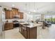 Stylish kitchen featuring stainless steel appliances, granite countertops, and a spacious island with seating at 2621 Redblush Ter, St Cloud, FL 34772