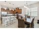 Modern kitchen with granite countertops, stainless steel appliances, and an adjacent dining area at 2621 Redblush Ter, St Cloud, FL 34772