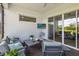 Cozy outdoor patio featuring a seating area and entertainment unit with sliding glass door at 2621 Redblush Ter, St Cloud, FL 34772