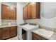 Laundry room with granite counters, cabinets, stainless steel appliances, and sink at 2621 Redblush Ter, St Cloud, FL 34772