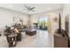 Bright living room with sliding glass doors and neutral decor, offering a comfortable and open space at 2621 Redblush Ter, St Cloud, FL 34772