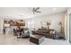 Open concept living area with ample seating, flowing into a modern kitchen and dining space at 2621 Redblush Ter, St Cloud, FL 34772