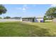 Large backyard featuring well-kept lawn and partial fence at 2626 Gentre St, Kissimmee, FL 34744