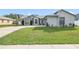 Well-maintained single-story home with lush green lawn and a basketball hoop on the driveway at 2626 Gentre St, Kissimmee, FL 34744