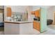 Bright kitchen with wooden cabinets, a breakfast bar, and a view into the living room at 2626 Gentre St, Kissimmee, FL 34744