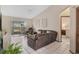 Bright living room featuring tile floors, a ceiling fan, and a sliding glass door leading to the outside at 2626 Gentre St, Kissimmee, FL 34744