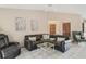 Cozy living room with tile floors, a ceiling fan, and comfortable leather furniture at 2626 Gentre St, Kissimmee, FL 34744