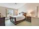 Bedroom featuring a sleigh bed, vaulted ceiling, and a large window with view of the outdoors at 2626 Gentre St, Kissimmee, FL 34744