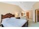 Bedroom featuring a sleigh bed, vaulted ceiling, and an ensuite bathroom at 2626 Gentre St, Kissimmee, FL 34744