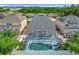 Aerial view of home showcasing the private pool, enclosed lanai and lush green backyard at 2669 Sand Hill Point Cir, Davenport, FL 33837
