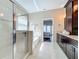 Bright bathroom featuring a glass shower, soaking tub, dark cabinets, and neutral tile flooring at 2669 Sand Hill Point Cir, Davenport, FL 33837