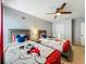 Charming bedroom with two twin beds featuring playful Mickey Mouse themed decor and a ceiling fan at 2669 Sand Hill Point Cir, Davenport, FL 33837