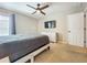 Comfortable bedroom with a queen bed, modern dresser, and a ceiling fan for added comfort at 2669 Sand Hill Point Cir, Davenport, FL 33837