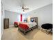 room showcasing two beds, ceiling fan, and decorated with a fun Mickey Mouse theme at 2669 Sand Hill Point Cir, Davenport, FL 33837