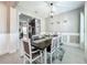Elegant dining room with modern lighting, neutral decor, and a view into the kitchen at 2669 Sand Hill Point Cir, Davenport, FL 33837