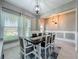 Elegant dining room featuring a dark wood table, stylish chairs, and light fixtures that enhance the room's appeal at 2669 Sand Hill Point Cir, Davenport, FL 33837