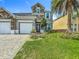 Charming home featuring a stone facade, well-maintained landscaping, and a convenient three-car garage at 2669 Sand Hill Point Cir, Davenport, FL 33837