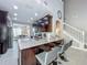Modern kitchen with a granite island and seating, view to the dining room, and staircase at 2669 Sand Hill Point Cir, Davenport, FL 33837