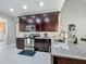 Modern kitchen equipped with stainless steel appliances, granite countertops, and dark wood cabinets at 2669 Sand Hill Point Cir, Davenport, FL 33837