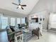 Bright living room featuring vaulted ceilings, large windows, comfortable seating, and a stylish area rug at 2669 Sand Hill Point Cir, Davenport, FL 33837