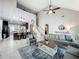 Open concept living room featuring a vaulted ceiling, stylish furnishings, and seamless flow to the kitchen at 2669 Sand Hill Point Cir, Davenport, FL 33837