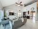 Open-concept living room featuring a vaulted ceiling, built-in shelving, and modern furnishings at 2669 Sand Hill Point Cir, Davenport, FL 33837