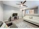 Upstairs loft with wood laminate flooring, white sofa and ceiling fan at 2669 Sand Hill Point Cir, Davenport, FL 33837