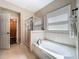 Bathroom features a soaking tub, shower, and access to a walk-in closet at 2669 Sand Hill Point Cir, Davenport, FL 33837