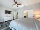 Cozy bedroom with herringbone floors, and a modern dresser and TV at 2669 Sand Hill Point Cir, Davenport, FL 33837