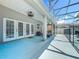 A covered patio features tiled flooring, ceiling fans, and outdoor furniture for relaxing and entertaining at 2669 Sand Hill Point Cir, Davenport, FL 33837