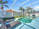 A beautiful fenced pool is surrounded by lush landscaping and lounge chairs for ultimate relaxation at 2669 Sand Hill Point Cir, Davenport, FL 33837
