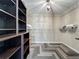 Spacious walk-in closet with custom shelving and laminate floors in a herringbone pattern at 2669 Sand Hill Point Cir, Davenport, FL 33837