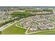 Stunning aerial shot showcases the community's lush landscaping and tranquil pond at 2690 Pleasant Cypress Cir, Kissimmee, FL 34741