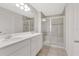 Bright bathroom featuring a double sink vanity and glass-enclosed shower at 2690 Pleasant Cypress Cir, Kissimmee, FL 34741
