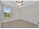 Neutral bedroom with window offering natural light and carpeted floors at 2690 Pleasant Cypress Cir, Kissimmee, FL 34741