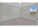 Bedroom with neutral walls and flooring, bright natural light from a window at 2690 Pleasant Cypress Cir, Kissimmee, FL 34741