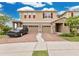 Inviting two-story home featuring a brick driveway and a two-car garage at 2690 Pleasant Cypress Cir, Kissimmee, FL 34741